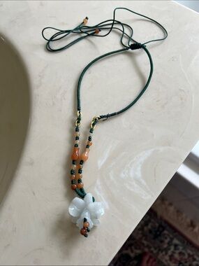 Handcrafted Green Cord Necklace with White Floral Pendant and Caramel Beads